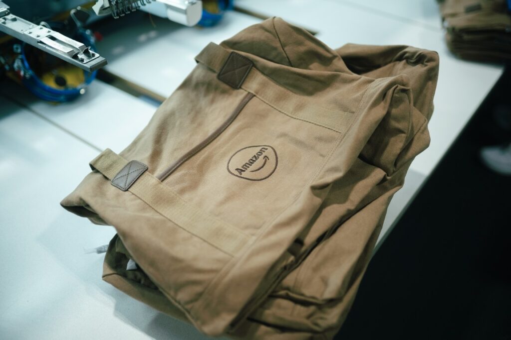 Tan canvas work jacket with a tonal embroidered logo, decorated in-house in Naples, FL