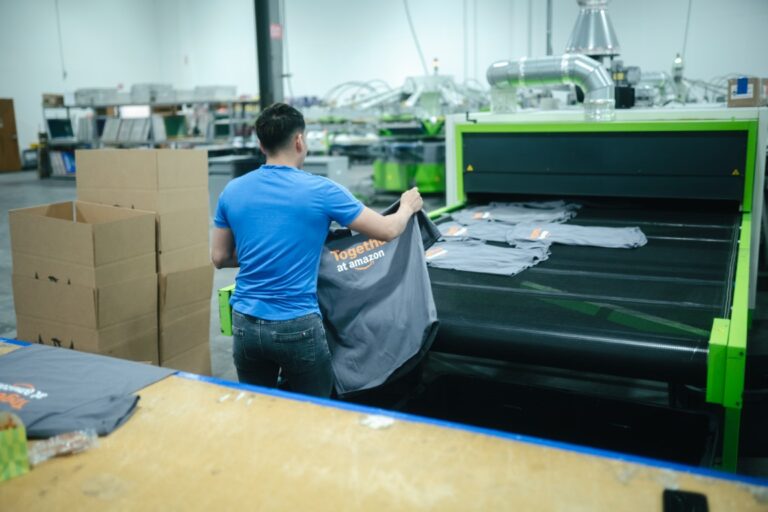 Custom screen printed t-shirts coming off the press