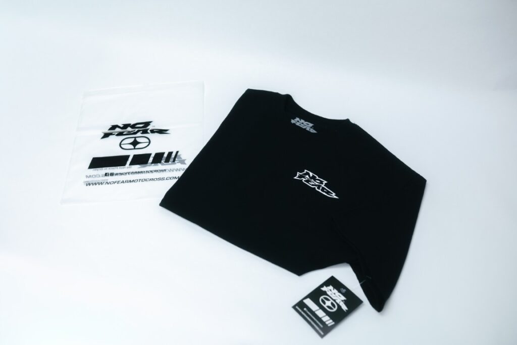 Retail-ready black tee with custom hang tag and printed neck label, finished in-house in Naples, FL